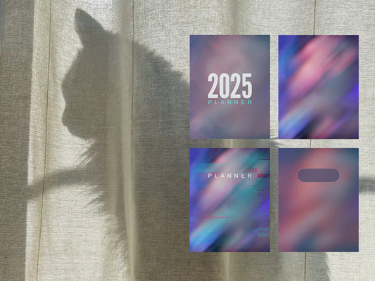 Planner covers with '2025' and 'PLANNER' text, casting a shadow on a textured surface.